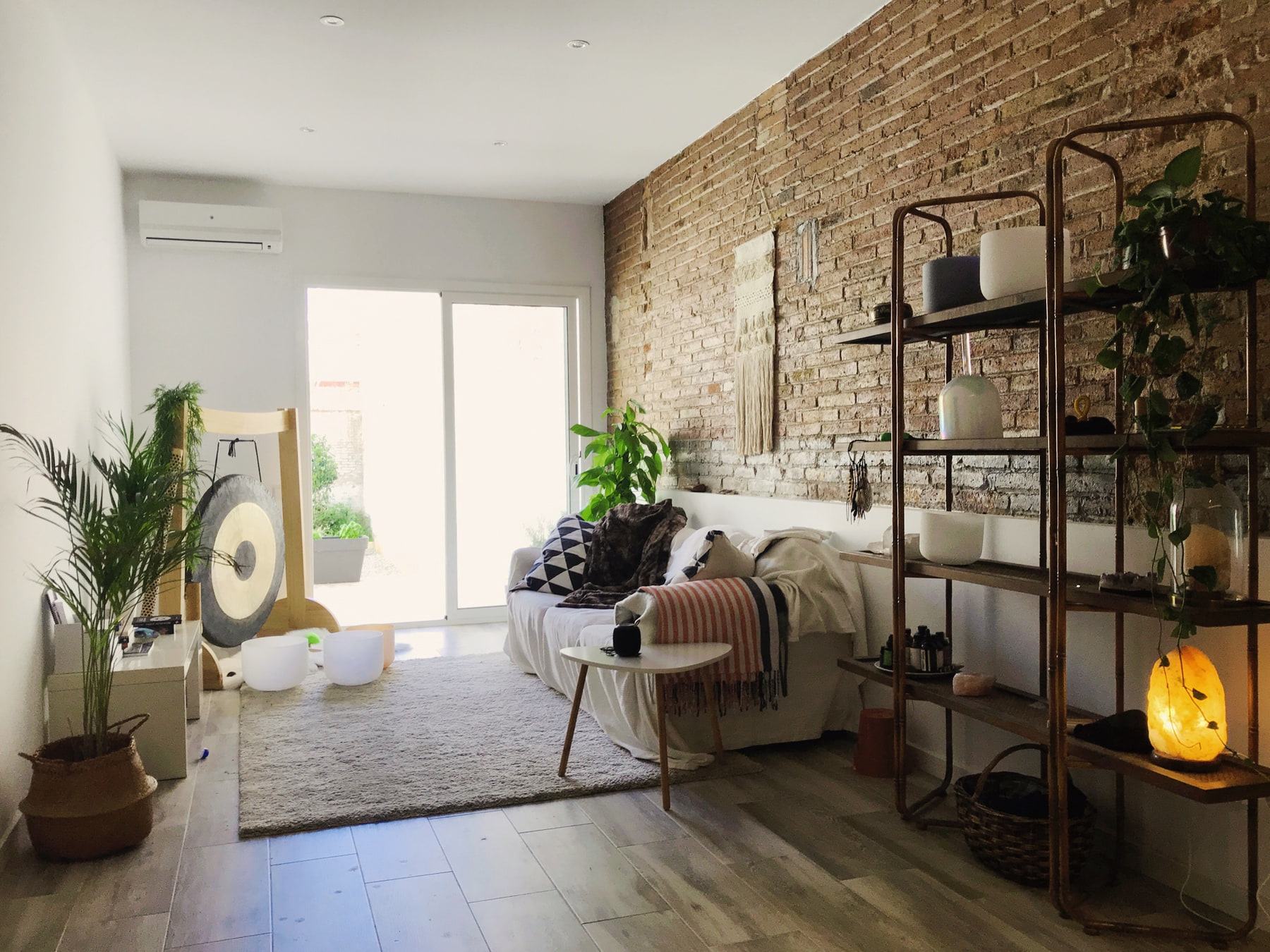 Jessica's Barcelona home with plants, a gong and sound-healing instruments.
