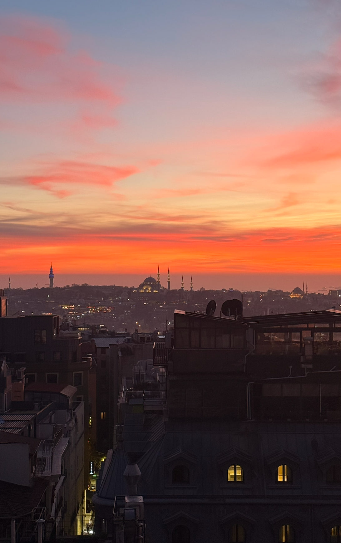 Istanbul skyline and the Bosphorus beneath a vivid sunset.